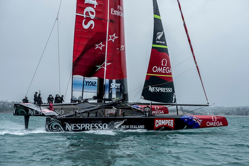 Sail-World’s Richard Gladwell (red wet weather gear) , checks out the wingsail twist as Emirates Team New Zealand’s AC72 rips across the Hauraki Gulf at speeds of over 40kts © Chris Cameron/ETNZ http://www.chriscameron.co.nz